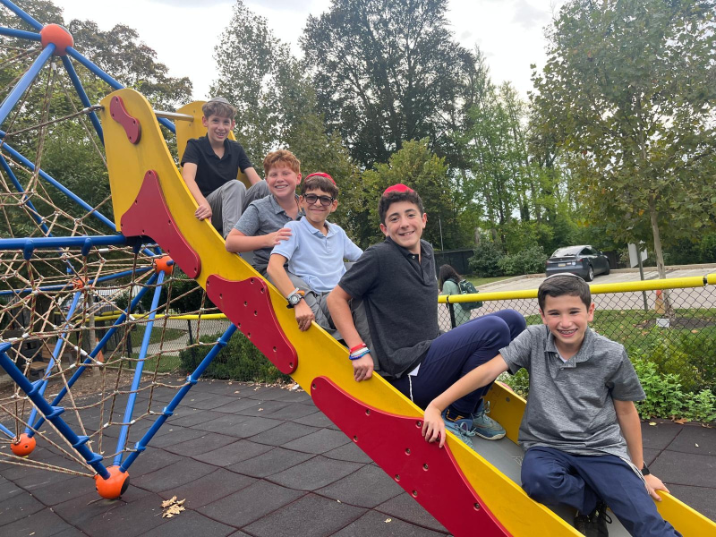 Boys playing on playground slide