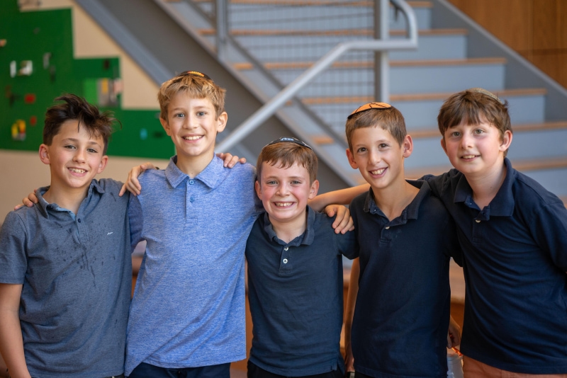 Five young boys standing together