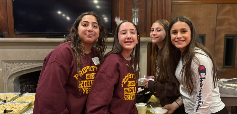 Four girls posing in sweatshirts