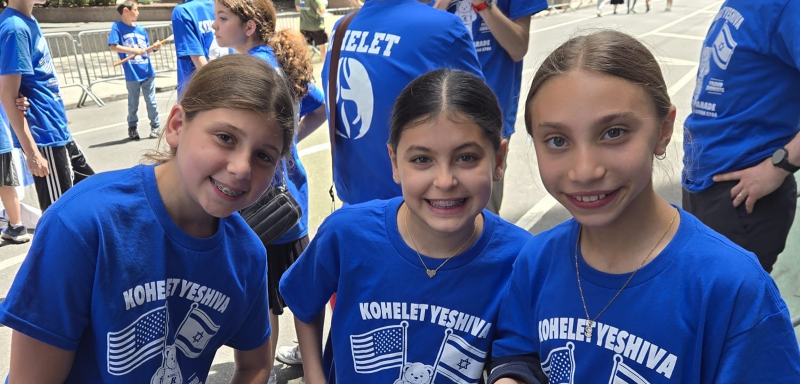 Three smiling girls in blue