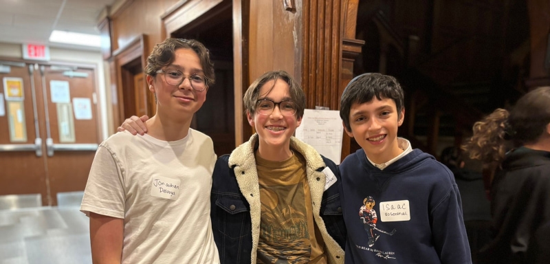 Three teenage boys smiling together