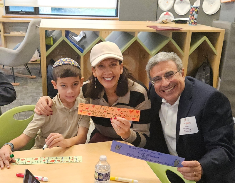 Family smiling at activity table