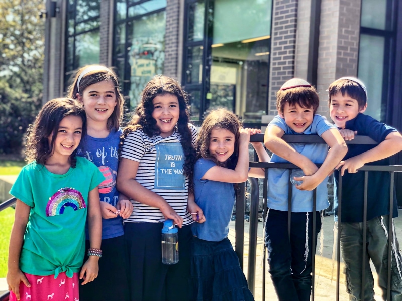 Children smiling on playground porch