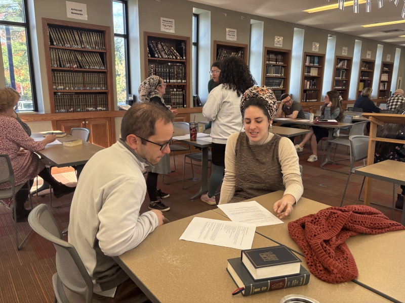 People studying at library tables